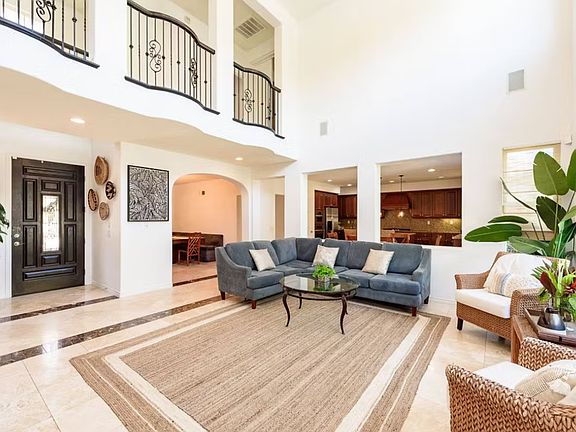 Light-filled, vaulted ceiling great room, boasting two-story windows.