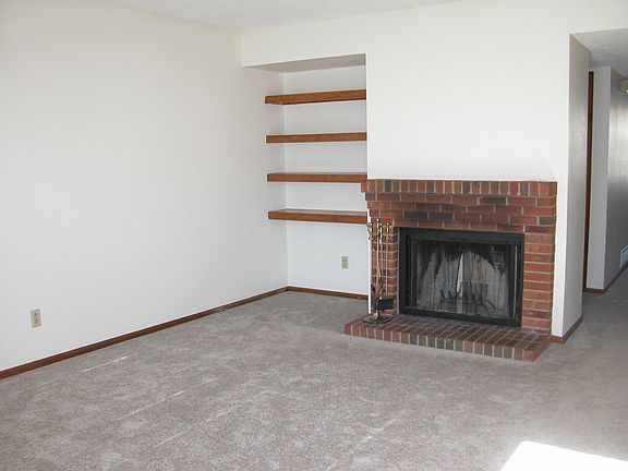 front room with fireplace and built in shelving