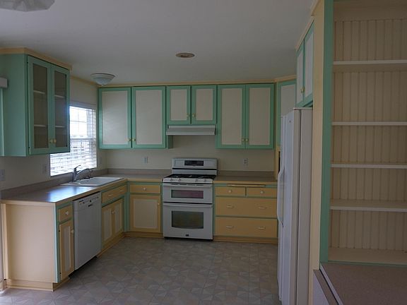 Charming kitchen with room for table and chairs.