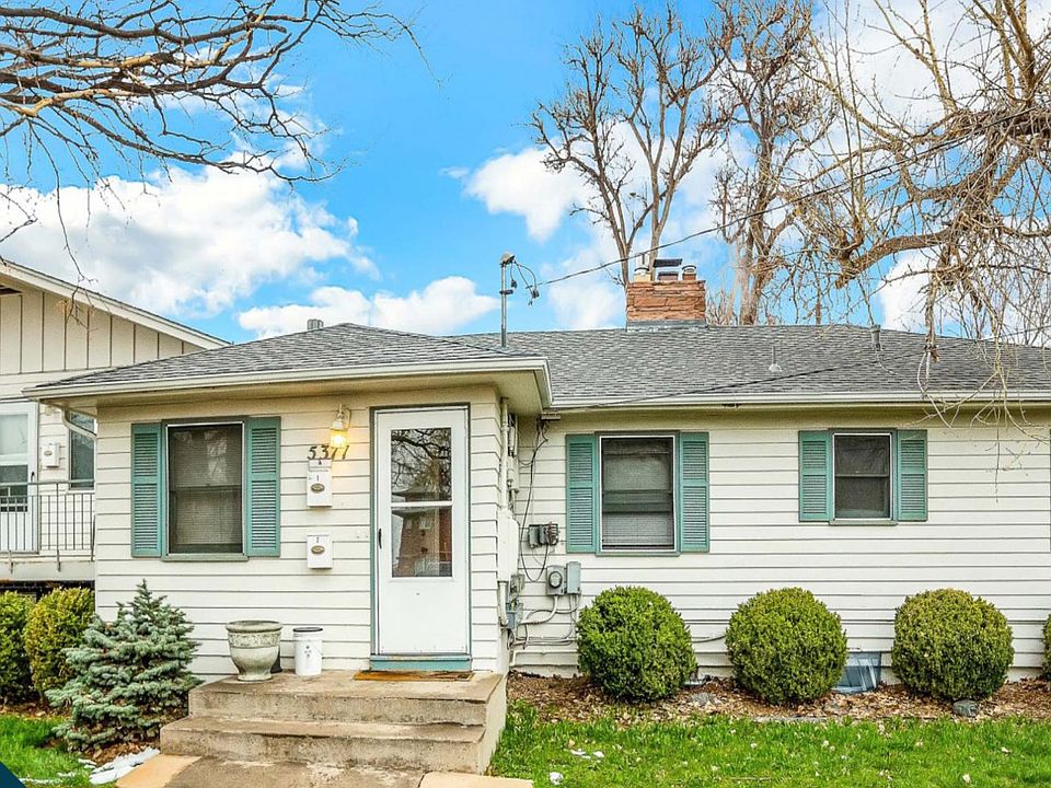 This is a photo of the entire apartment building. 6 units in total. This is a quiet neighborhood with 3 parks close by 
 Large front yard and sitting area/balcony in back of unit as well as common areas