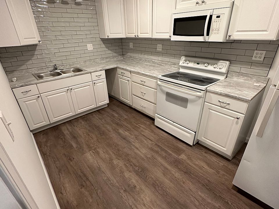 Full kitchen with oven, microwave, refrigerator, and freezer.