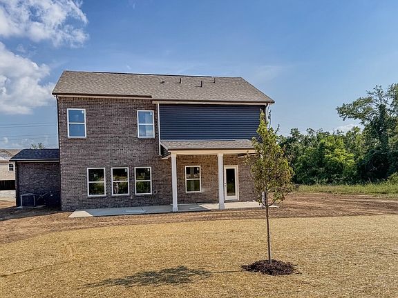 Photo of actual home, July 2026. Extended, covered rear patio!