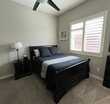 Bedroom 2 with Queen size bed, tall boy dresser, bookshelf, nightstand and ceiling fan