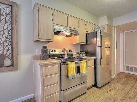 Kitchens include electric appliances including stove, refrigerator, & dishwasher
