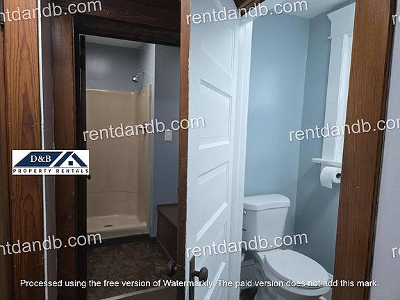 Bathroom has 2 separate areas, toilet and sink room and separate shower room with a storage closet.