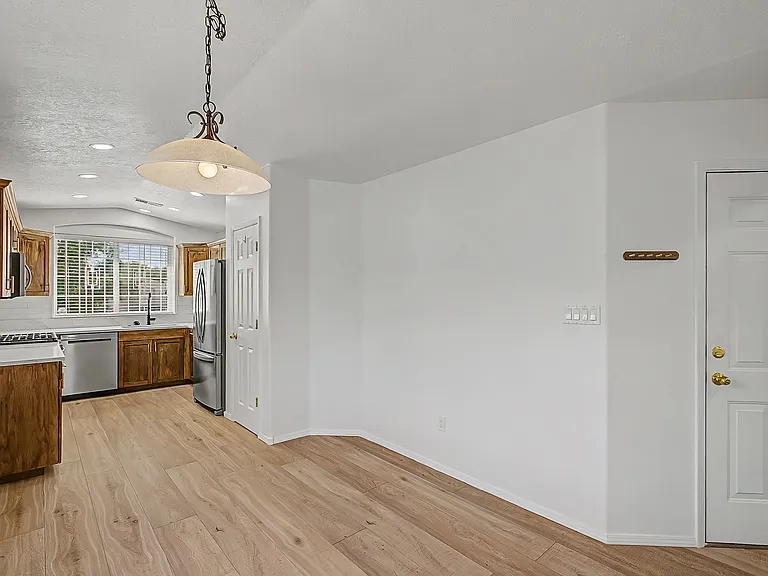 Kitchen area and view towards garage entrance.