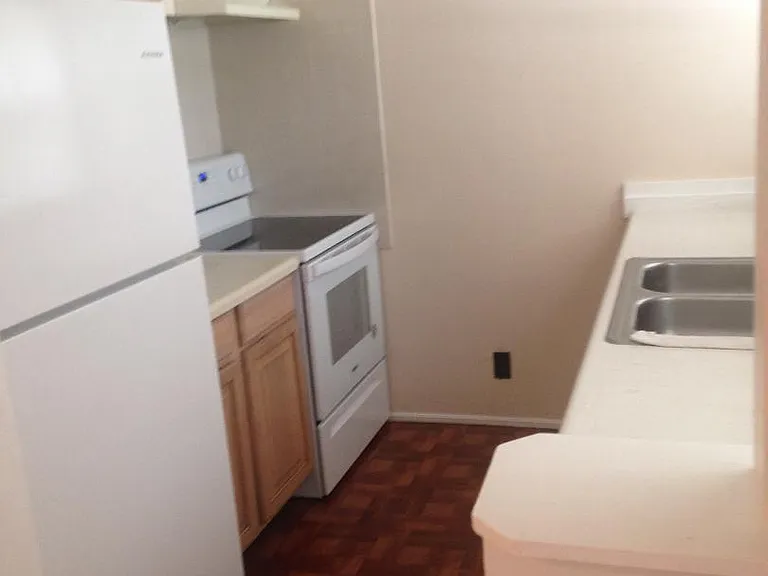 Kitchen ice maker in fridge, glass top stove.
