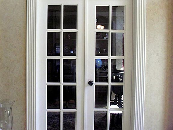 STYLISH FRENCH DOORS FRAME THE ENTRANCE TO THE STUDY.