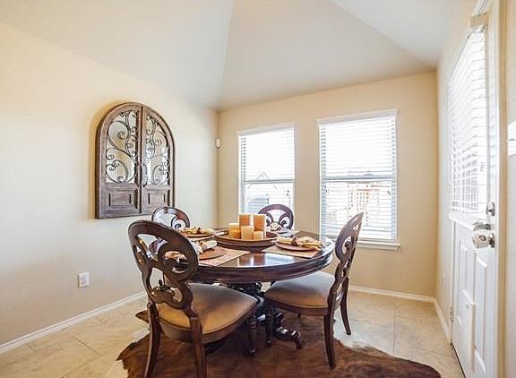 Charming breakfast nook with 18' ceramic tile and cathedral ceiling