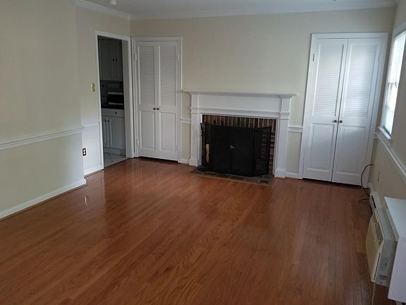 Spacious LR w/ gleaming hardwoods and fireplace