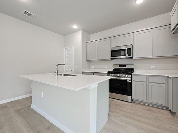 Kitchen in the Willow home plan by Trophy Signature Homes - REPRESENTATIVE PHOTO