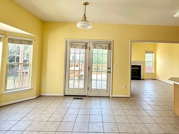Level 2: Kitchen open to breakfast room and family room with a gas fireplace.
