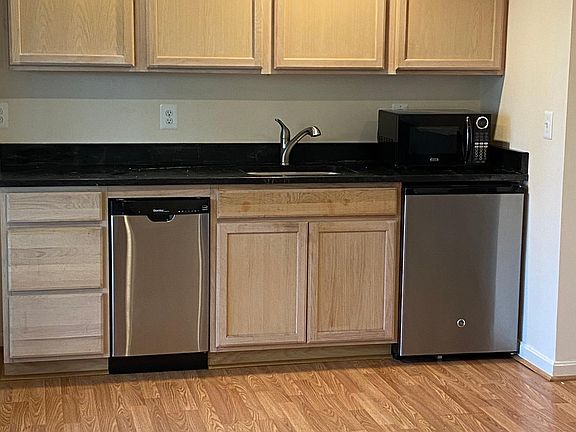 modern kitchen with dishwasher, refrigerator, microwave and soapstone counter top