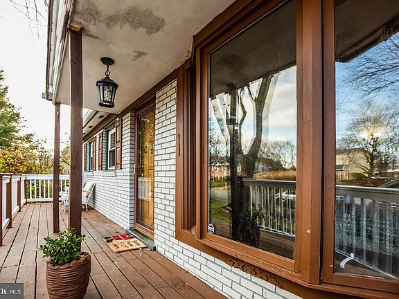 Deep front porch runs the length of the home