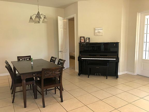 Tuned piano in living room. Door to master bedroom. And back door to back lanai