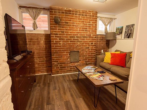 Separate living room with queen-size pull-out couch and TV