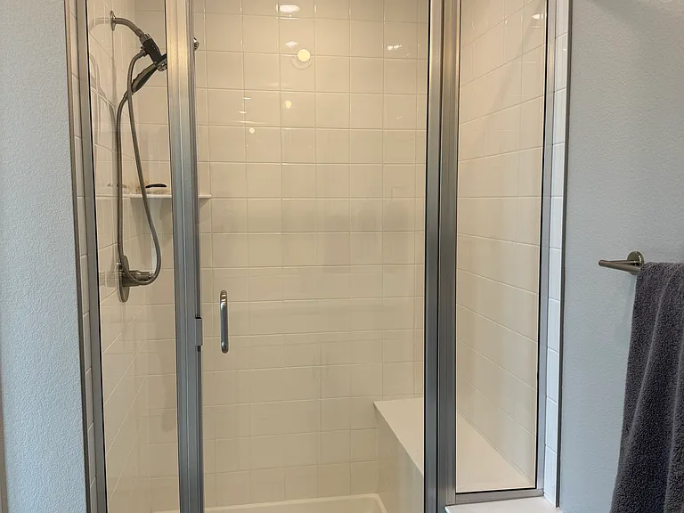 Glass door for walk in shower with bench