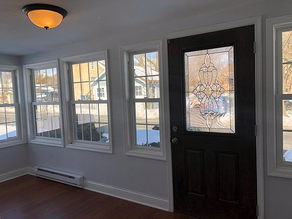 Heated enclosed front porch looking toward front of house and street