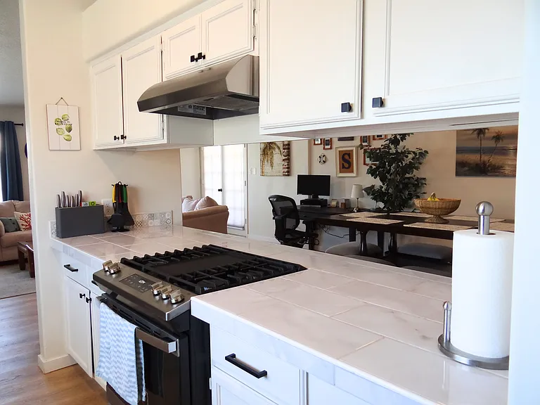 Enjoy the convenience of a gas cooktop, complete with pots, pans, and dishware at your fingertips.