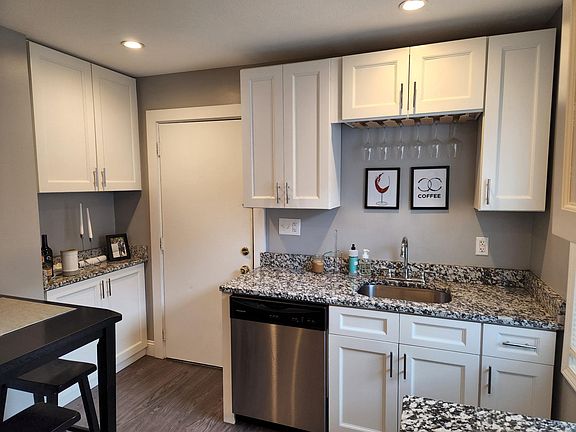 Newer kitchen with high end white shaker cabinets and granite countertop. Newer stainless steel