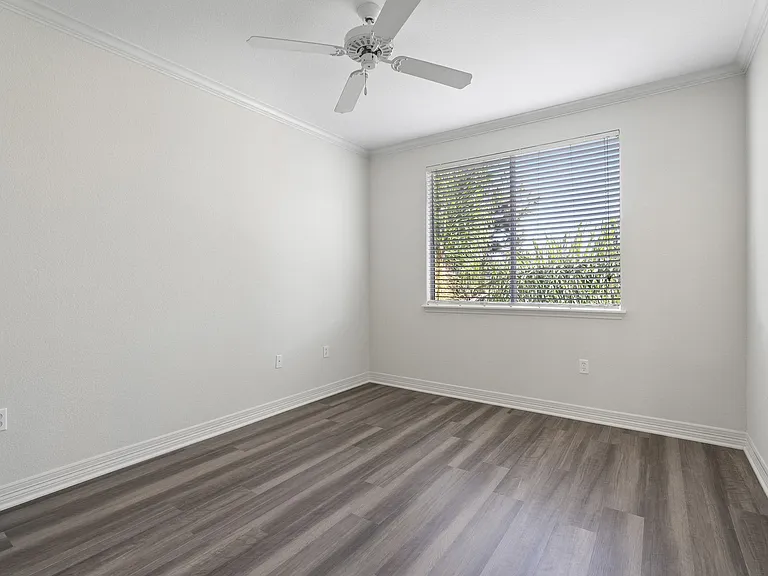 Wood-style flooring extends to the bedroom