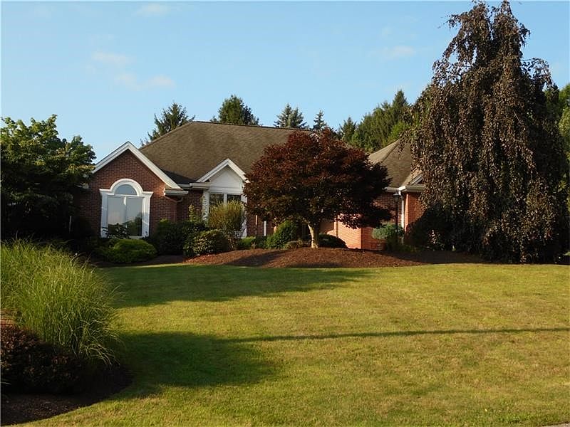 Exquisite custom home surrounded by lavishing landscaping