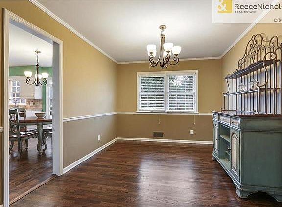 Dining room with refinished hardwood floors and beautiful color palette.