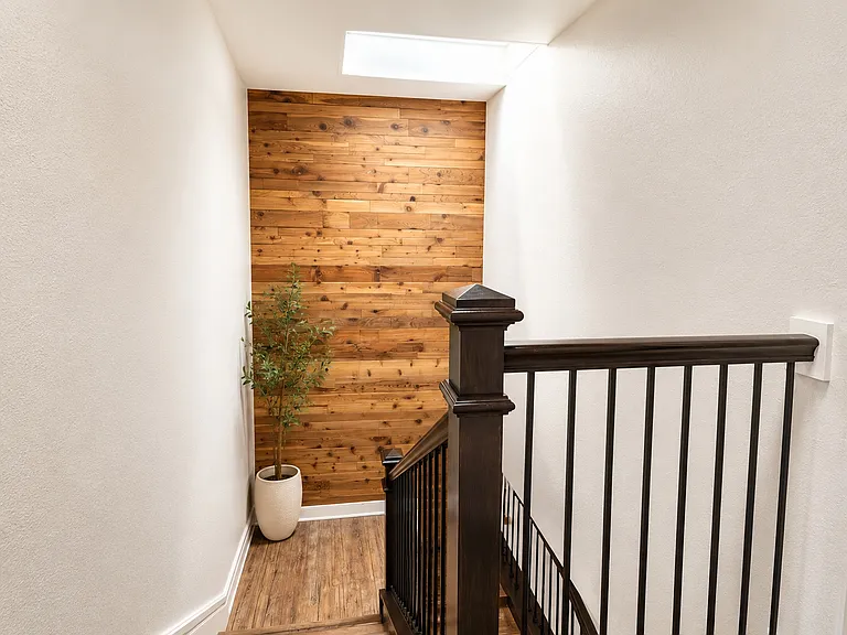 Really great staircase with a wood accent wall & a skylight for extra natural light.