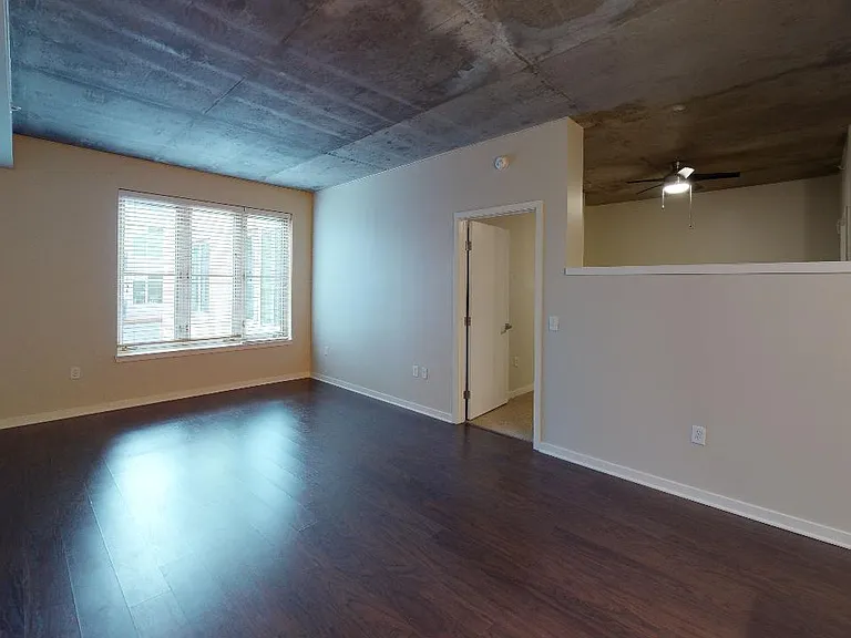 Apartment living room with wood-style flooring.
