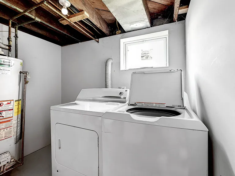 Laundry room in lower level with full-size washer and dryer