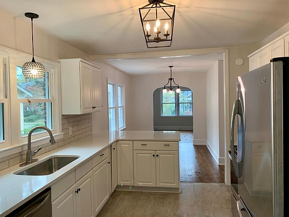 Kitchen opens to dining area which opens to the living space