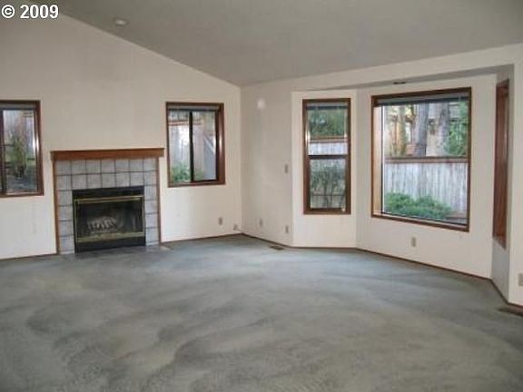 Vaulted ceiling and wood fireplace in Family Room