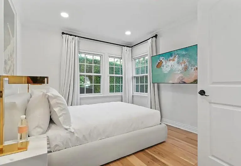 Rest and relaxation in the 3rd Guest Bedroom with a queen-size bed and a large Smart TV.