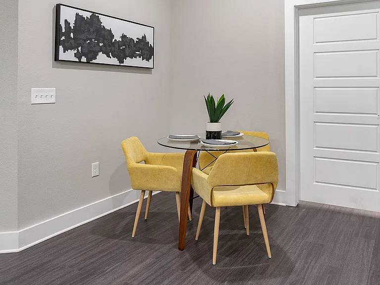 Experience elegance in this inviting dining nook adorned with contemporary art.