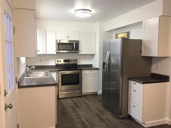 Bright Kitchen with newer cupboards, appliances, flooring, and paint.