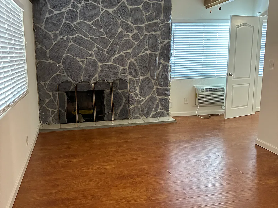 Master with fireplace and wood beamed ceilings.