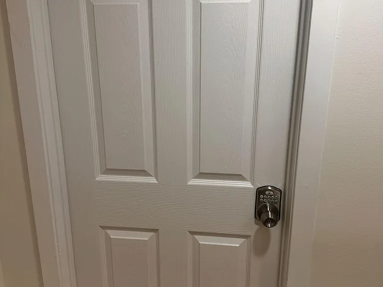 Private interior entry door with keypad lock provides convenient, secure access to the room from the hallway.