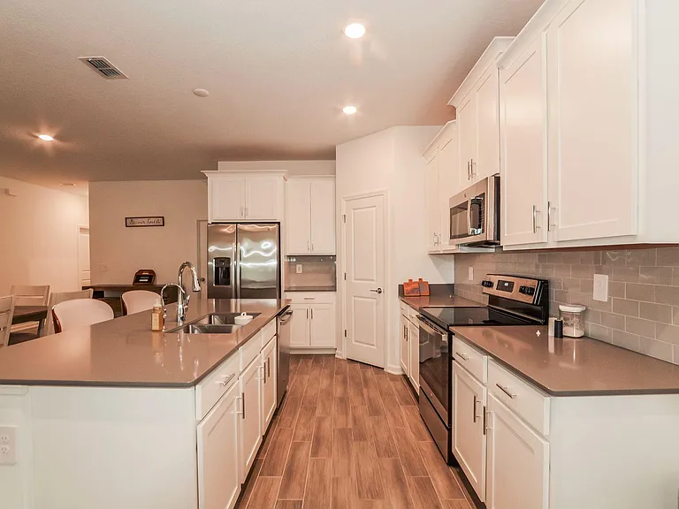 Spacious kitchen with large island seating, ample cabinet storage, and stainless steel appliances for everyday cooking.