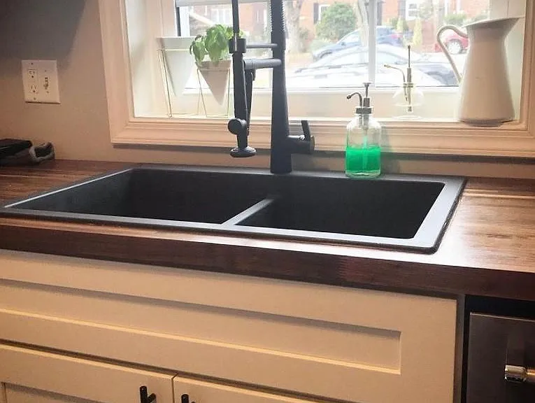 Kitchen walnut butcher block counters, black granite sink with chef's faucet.