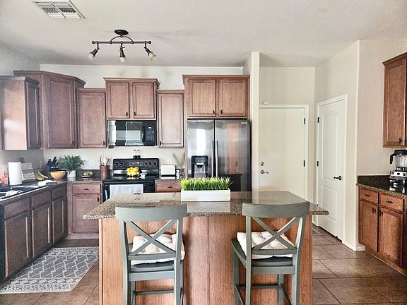 Kitchen shown with refrigerator (provided)