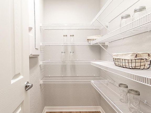 A walk-in pantry provides storage convenience - Parkerby Highland Homes