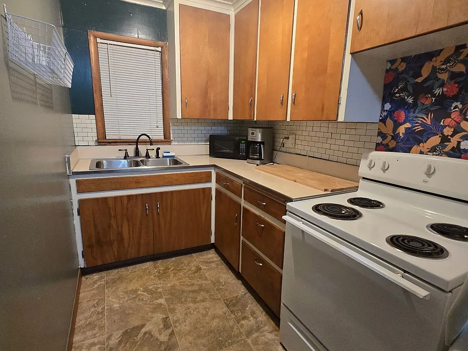 Kitchen with electric range.