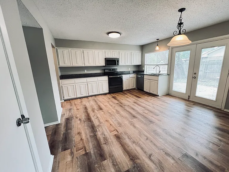 Appliances include dishwasher, digital smooth glass cooktop stove with self-cleaning oven, microwave and garbage disposal. Plenty of counter space