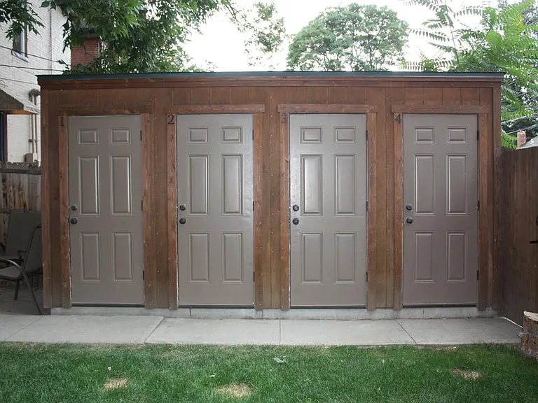 Back yard with 1 storage unit per apartment. Deep enough for bikes and skis and much more.