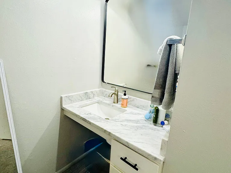 Experience elegance with this modern bathroom vanity, complete with luxurious marble and stylish fixtures.