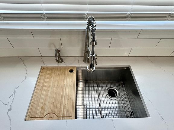 Kraus sink with cutting board insert, Krauss faucet and on demand hot water dispenser.