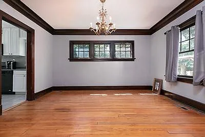 Dining room. Oak Floors. 3 windows open to back yard. Antique Brass Chandelier.
