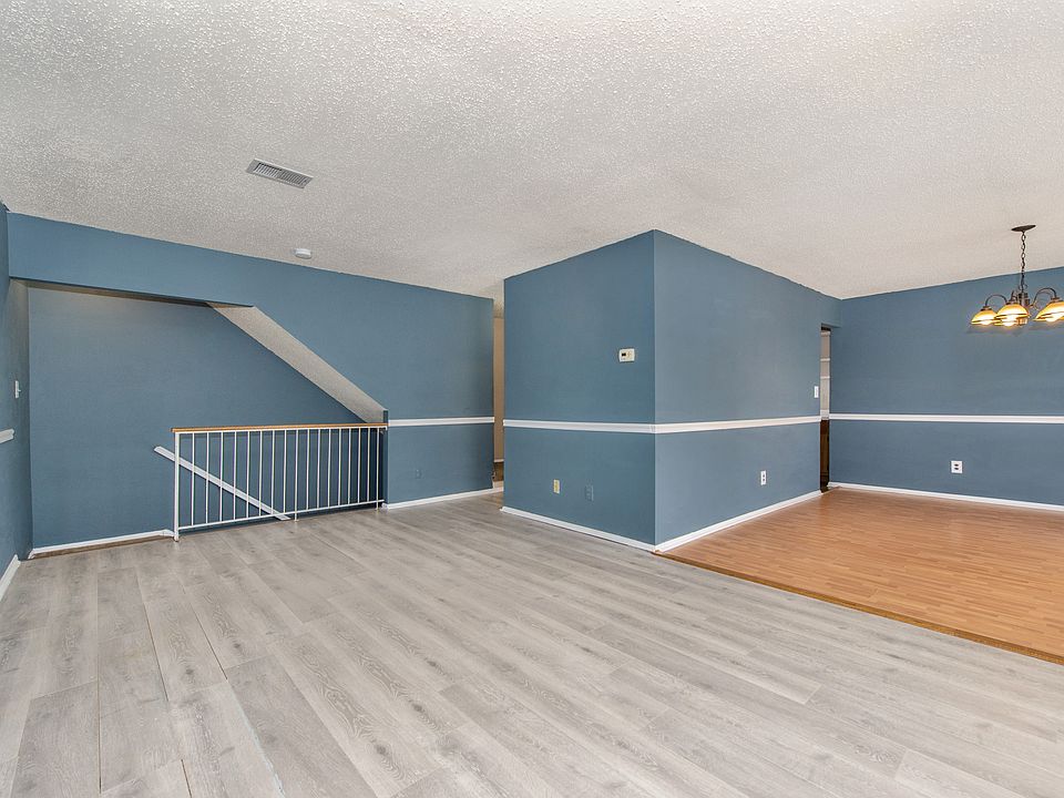 Spacious living area with stairs to ground floor entrance.