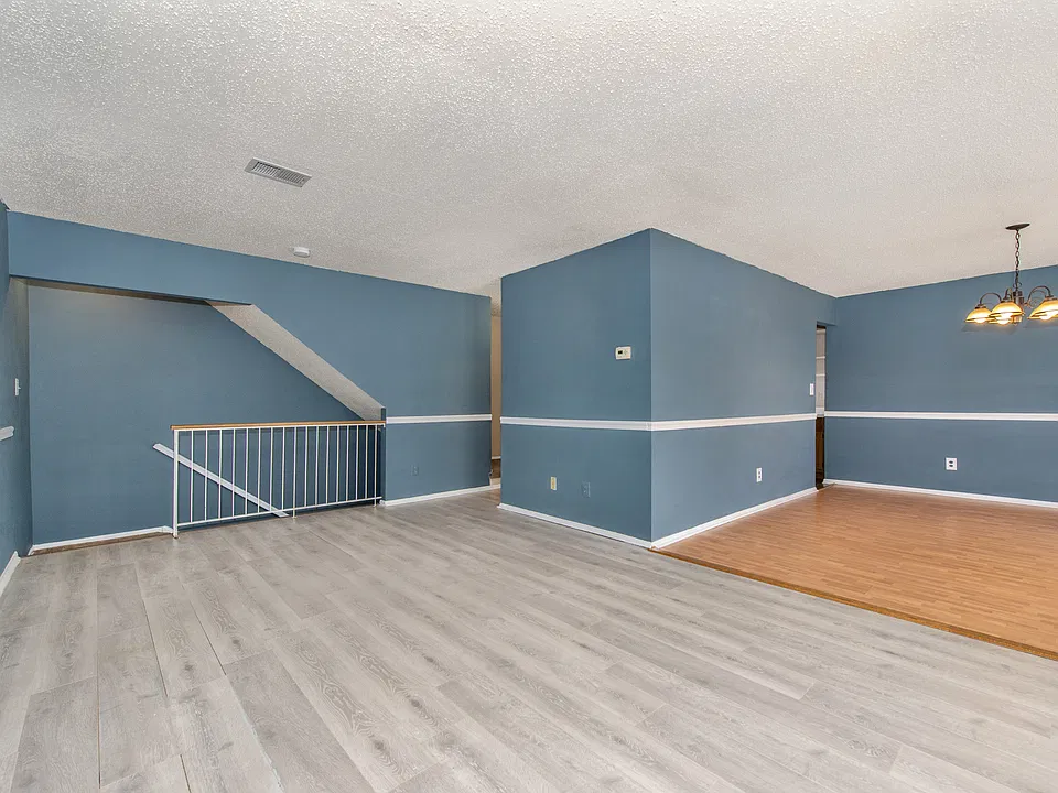 Spacious living area with stairs to ground floor entrance.
