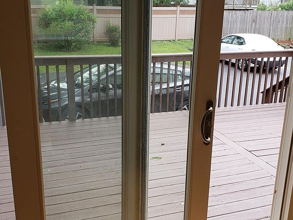 Deck and 2 parking spaces at back of house seen through slid
